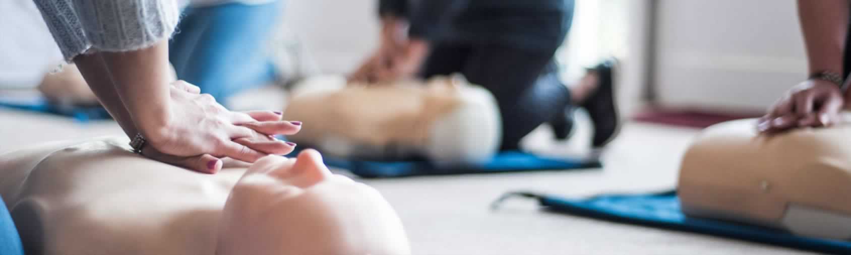 CPR hands performing chest compressions during first aid training